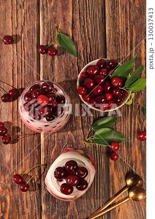 Cherry yogurt with berries in a glass on an elegant table, fruit salad, detox diet and natural nutrition concept, healthy breakfast with ingredients.advertisement of a healthy lifestyle 130037413