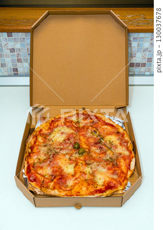 Pizza in open cardboard box 130037678