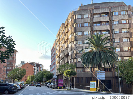 A wide-angle street view of a large residential building in a European city, Aviles, Asturias A wide-angle street view of a large residential building in a European city, Aviles, Asturias 130038057