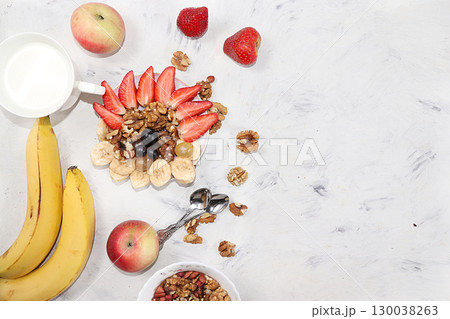 Granola and fresh strawberries and grapes on a light table. The concept of healthy and natural nutrition, diet healthy dessert. Healthy breakfast, funny food for children, lifestyle, I love my body, 130038263