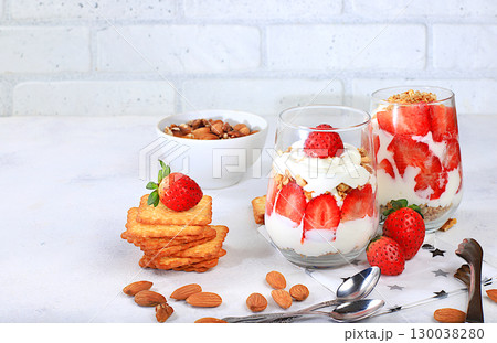 Strawberry yogurt with berries, French cracker and granola on a bright table, fruit salad, detox diet and natural nutrition concept, Healthy breakfast with ingredients. lifestyle, baby food, selective Strawberry yogurt with berries, French cracker and granola on a bright table, fruit salad, detox diet and natural nutrition concept, Healthy breakfast with ingredients. lifestyle, baby food, selective 130038280