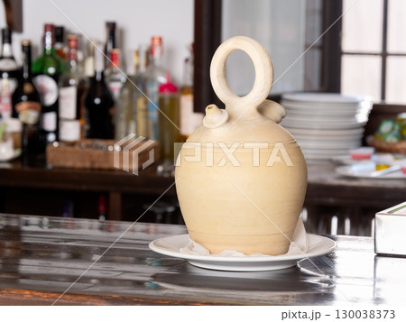 Traditional Ceramic Wine Pitcher on a Bar Counter 130038373