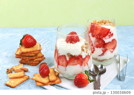 Strawberry yogurt with berries, French cracker and muesli on a bright table, fruit salad. Healthy breakfast with ingredients, natural food concept, lifestyle, food for children, selective focus, place Strawberry yogurt with berries, French cracker and muesli on a bright table, fruit salad. Healthy breakfast with ingredients, natural food concept, lifestyle, food for children, selective focus, place 130038609