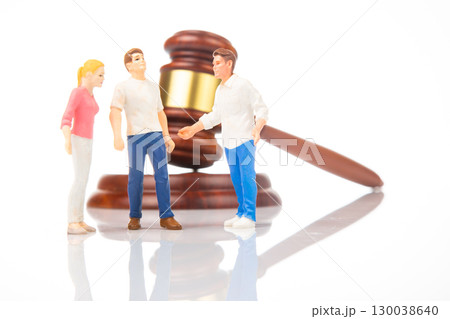 Miniature figures discussing legal matters near a gavel Miniature figures discussing legal matters near a gavel 130038640