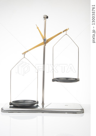 Balance scale positioned for precise measurements in a bright studio setting 130038761