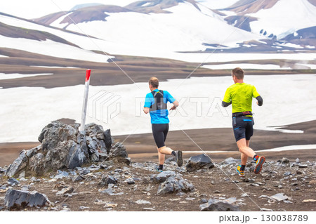 Runners navigate rocky terrain in Iceland stunning landscape during summer 130038789