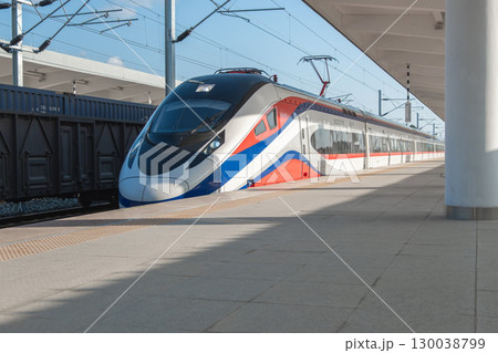Vang Vieng, Laos - December 30, 2022: Modern high-speed train at station platform ready for departure Vang Vieng, Laos - December 30, 2022: Modern high-speed train at station platform ready for departure 130038799