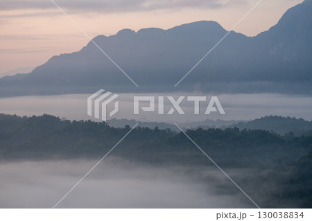 Mountain landscape with morning fog and forest in peaceful natural setting at Phadeng Peak, Luang Prabang, Laos Mountain landscape with morning fog and forest in peaceful natural setting at Phadeng Peak, Luang Prabang, Laos 130038834