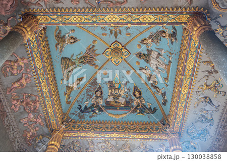 Patuxai war monument arch in Vientiane Laos Intricate traditional mural painting on temple ceiling with mythological figures 130038858