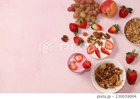 Useful breakfast, food for children, strawberry yogurt and granola, on a bright table. The concept of healthy and natural food. selective focus Useful breakfast, food for children, strawberry yogurt and granola, on a bright table. The concept of healthy and natural food. selective focus 130039004