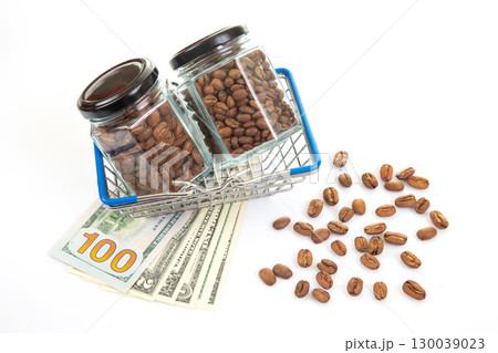 Dollar bills and coffee beans in miniature shopping carts on a white background Dollar bills and coffee beans in miniature shopping carts on a white background 130039023