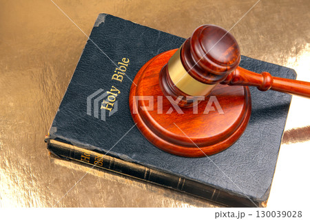 Detailed image of a courtroom gavel resting on a "Holy Bible" with embossed gold text Detailed image of a courtroom gavel resting on a "Holy Bible" with embossed gold text 130039028