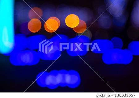 Abstract golden and vibrant light bokeh on a dark backdrop 130039057