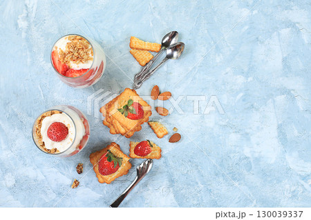 Strawberry yogurt with berries, French cracker and muesli on a bright table, fruit salad. Healthy breakfast with ingredients, natural food concept, lifestyle, food for children, selective focus, place Strawberry yogurt with berries, French cracker and muesli on a bright table, fruit salad. Healthy breakfast with ingredients, natural food concept, lifestyle, food for children, selective focus, place 130039337