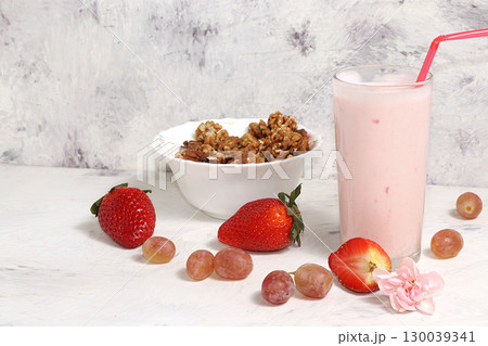 Useful breakfast, food for children, strawberry yogurt, smoothies and granola, on a light table. The concept of healthy and natural food. selective focus Useful breakfast, food for children, strawberry yogurt, smoothies and granola, on a light table. The concept of healthy and natural food. selective focus 130039341