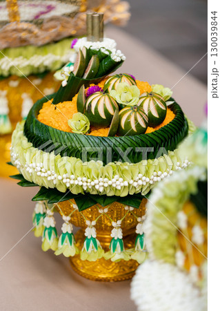 offerings in the traditional Thai wedding procession Khan Mak ceremony arrangements displayed on a table in a lush garden setting offerings in the traditional Thai wedding procession Khan Mak ceremony arrangements displayed on a table in a lush garden setting 130039844