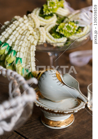 wedding concept, decorative glass bowl with beads and vintage items on wooden table wedding concept, decorative glass bowl with beads and vintage items on wooden table 130039859