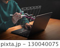Close-up of a person managing a digital project timeline on a laptop with a pen. Gantt chart interface shows task tracking, deadlines, and project progress in a modern work environment. 130040075