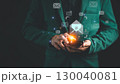 Businessman in a suit using a smartphone with floating email icons, representing digital communication, email marketing, online messaging, and modern technology in a professional environment. 130040081
