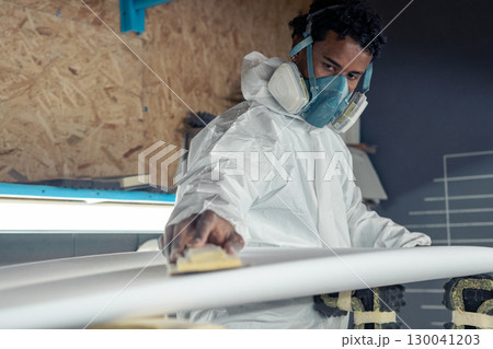 Shaper working on surf board 130041203