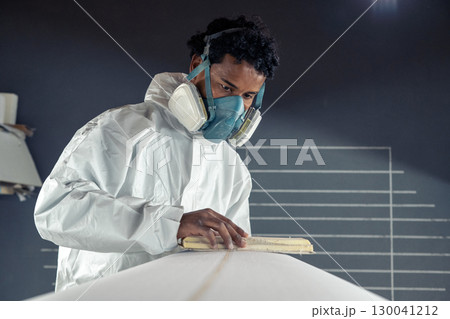 Shaper working on surf board 130041212