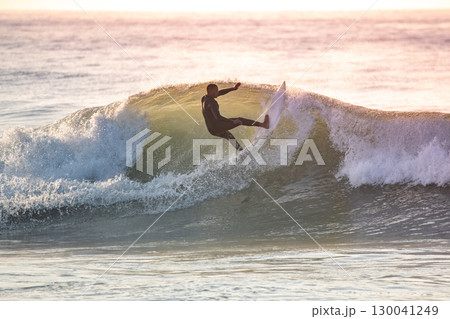 Young surfer enjoying waves 130041249
