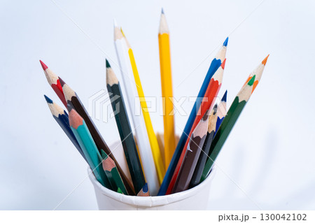 Colorful pencils standing in a paper cup on white background 130042102