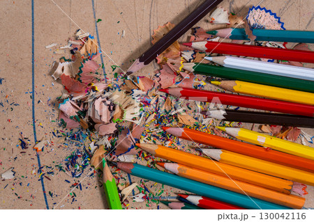 Colored pencils creating colorful shavings on cardboard Colored pencils creating colorful shavings on cardboard 130042116