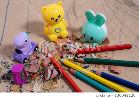 Colored pencils and pencil sharpeners creating a mess on cardboard Colored pencils and pencil sharpeners creating a mess on cardboard 130042120