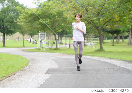 公園をランニングする女性 130044270