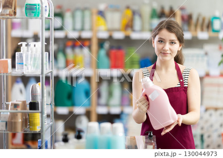 Saleswoman offers to buy detergent in supermarket Saleswoman offers to buy detergent in supermarket 130044973
