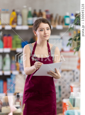 Woman conducts an inventory of a household warehouse Woman conducts an inventory of a household warehouse 130045128