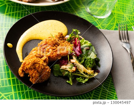 Chicken in panko roasted in tandoor with mousseline sauce Chicken in panko roasted in tandoor with mousseline sauce 130045497