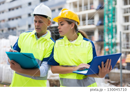 Two architects with laptop discussing construction plan Two architects with laptop discussing construction plan 130045710