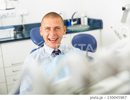 Portrait of happy man after surgery at dental blade Portrait of happy man after surgery at dental blade 130045967