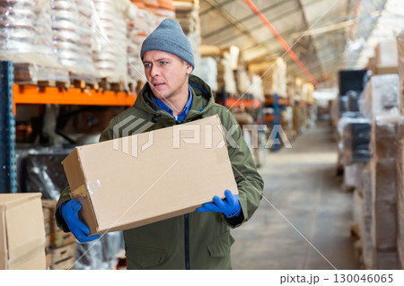 Storekeeper stacking pasteboard box in storehouse Storekeeper stacking pasteboard box in storehouse 130046065