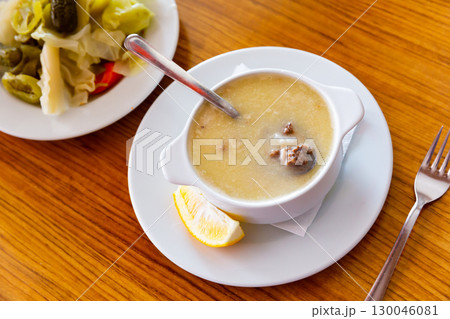 Turkish soup Paca corbasi served with pickle vegetables Turkish soup Paca corbasi served with pickle vegetables 130046081