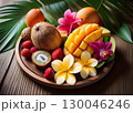 カットされ南国の花と一緒に盛り付けられたトロピカルフルーツ 130046246