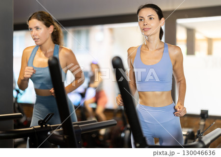 Woman exercising on a treadmill in the gym Woman exercising on a treadmill in the gym 130046636