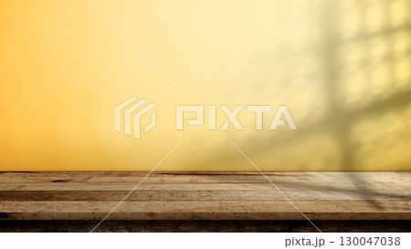 Rustic wooden table or shelf for product display with a yellow wall background. Product presentation, mockup, copy space, and template Rustic wooden table or shelf for product display with a yellow wall background. Product presentation, mockup, copy space, and template 130047038