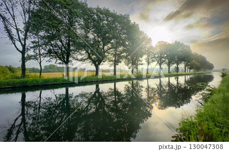 A Tranquil Reflection Over a Beautiful Scenic River Landscape at Radiant Dawn Light 130047308