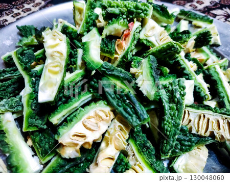 Sliced Bitter Gourd (Karela) in a Steel Plate 130048060