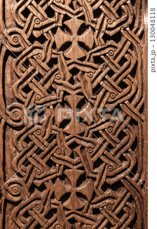Close-up photo of a traditional Armenian wooden carving featuring Cross elements 130048118