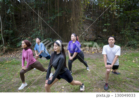 Indonesian southeast asian people in a sporty outfit practice exercise together in a public park outdoors. Concept of a Healthy active lifestyle Indonesian southeast asian people in a sporty outfit practice exercise together in a public park outdoors. Concept of a Healthy active lifestyle 130049033