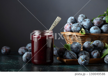 Ripe plums with jam on the kitchen table. 130049586