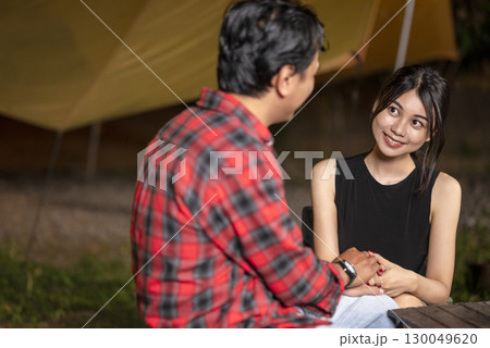 Indonesian southeast asian couple holding hands. The scene of love, togetherness, or cheating in a relaxed setting. The scene of the lifestyle of camping in a natural setting Indonesian southeast asian couple holding hands. The scene of love, togetherness, or cheating in a relaxed setting. The scene of the lifestyle of camping in a natural setting 130049620