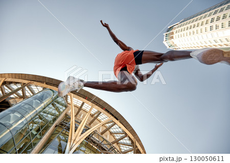 Athlete Jumps Over a Building Background Capturing Energy and Motion Athlete Jumps Over a Building Background Capturing Energy and Motion 130050611