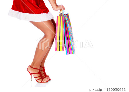 Woman in red dress with colorful shopping bags, isolated 130050631