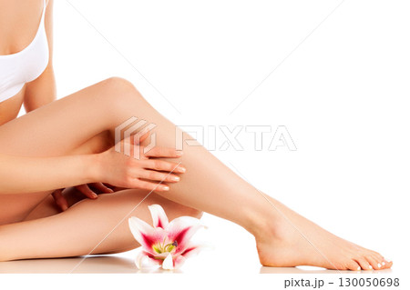 Young beautiful woman with gorgeous slim body and lily flower isolated on white background Young beautiful woman with gorgeous slim body and lily flower isolated on white background 130050698