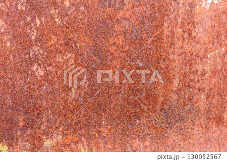 Red-brown texture of metal sheet.Completely rusted sheet metal.Metal corrosion.Rust texture close up. 130052567